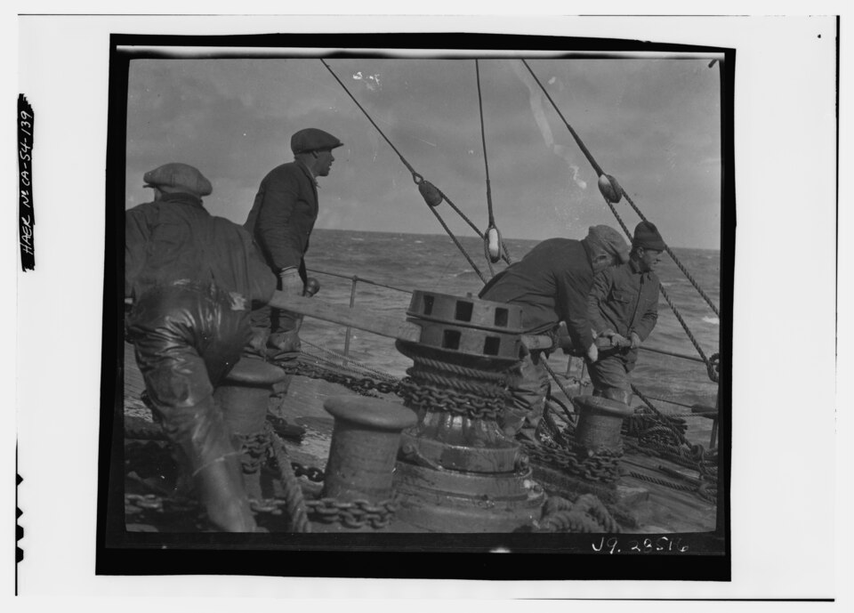 Crew members working the forecastle deck capstan aboard the ship Balclutha, 1925